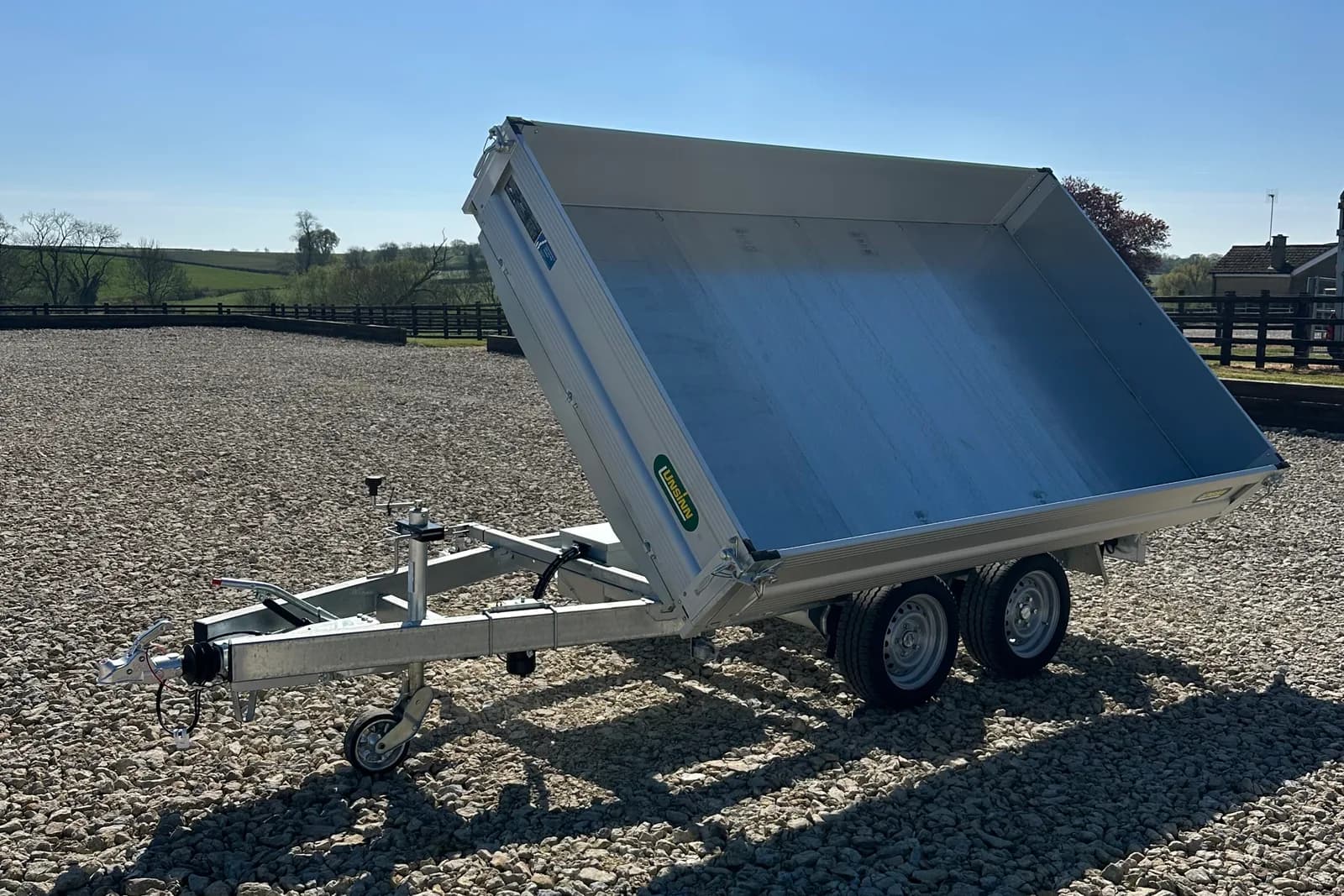 Tipper trailer with raised body on a UK builder's yard